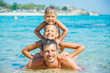 Family playing in the sea