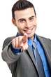 Handsome businessman pointing his finger at you