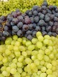 Blue and white grapes in a box at the greengrocer