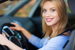 Smiling woman sitting in car