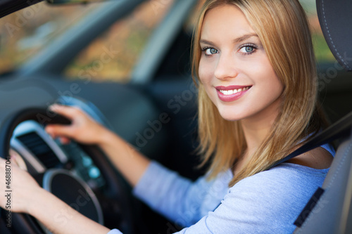 Photo: Smiling woman sitting in car Smiling woman sitting in car