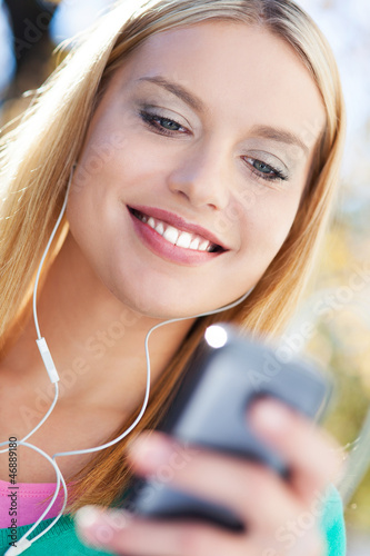 Photo: Young woman with music player Young woman with music player