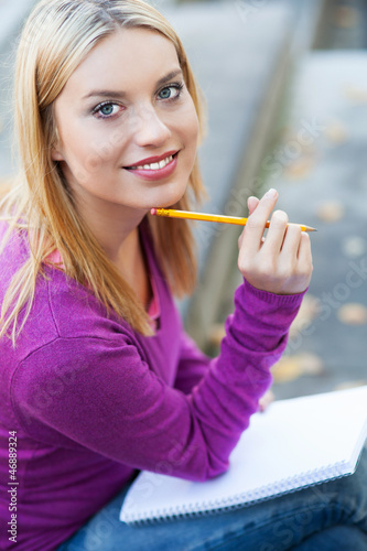 Photo: Student with notebook and pencil Student with notebook and pencil