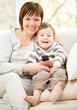 Mother and her son are watching tv
