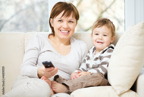 Photo: Mother and her son are watching tv Mother and her son are watching tv