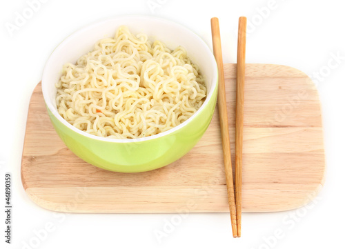 Photo: asian noodles in bowl on wooden board isolated on white asian noodles in bowl on wooden board isolated on white