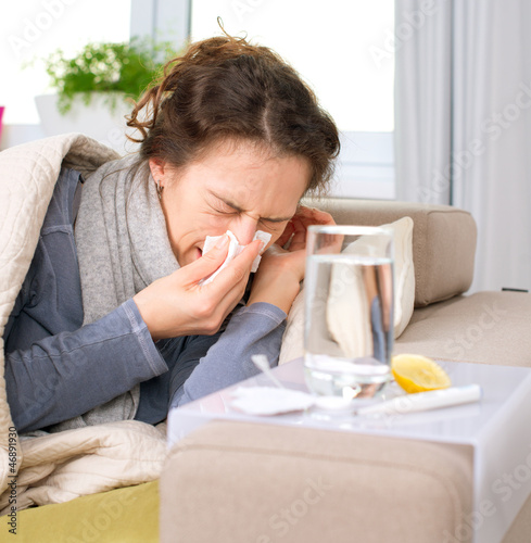Photo: Sick Woman.Flu.Woman Caught Cold. Sneezing into Tissue Sick Woman.Flu.Woman Caught Cold. Sneezing into Tissue