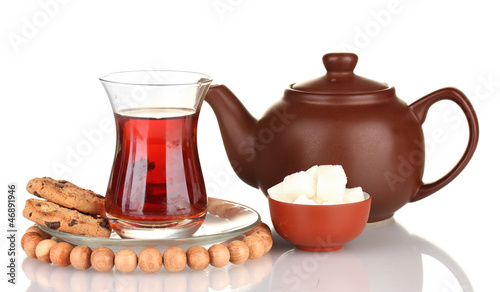 Photo: glass of Turkish tea and kettle isolated on white glass of Turkish tea and kettle isolated on white