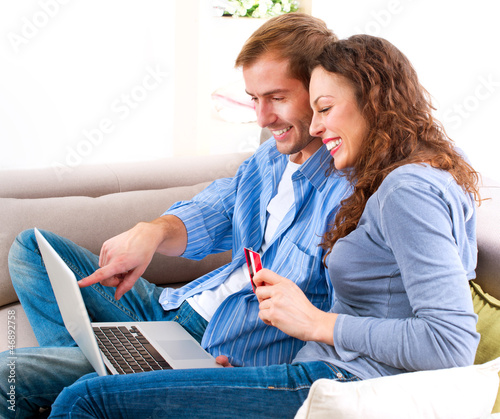 Photo: Online Shopping. Couple Using Credit Card to Internet Shop Online Shopping. Couple Using Credit Card to Internet Shop