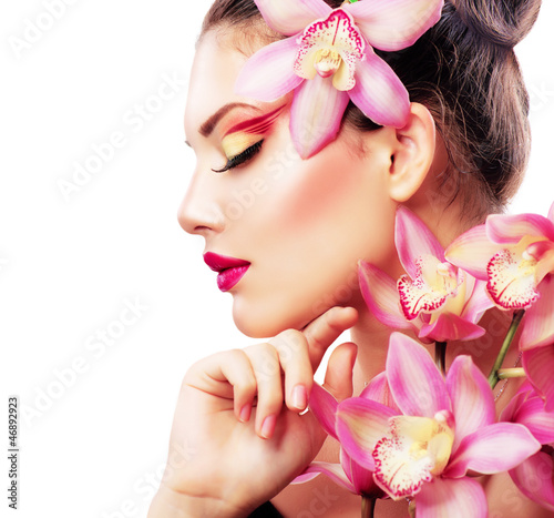 Photo: Beauty Portrait. Beautiful Stylish Girl with Orchid Flower Beauty Portrait. Beautiful Stylish Girl with Orchid Flower