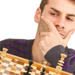 Chessboard with desperate man thinking about chess strategy, iso