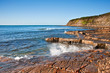 Kimmeridge Bay seascape with rock ledges extending out to sea on