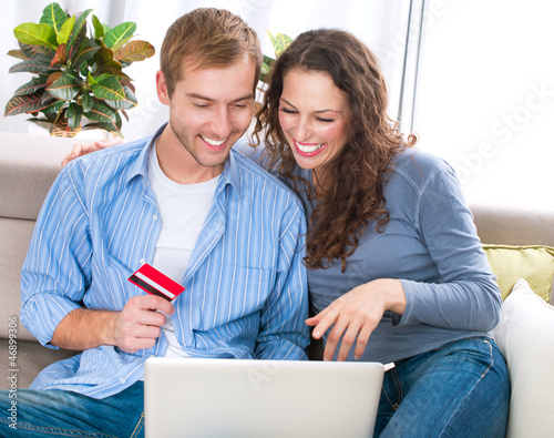 Photo: Online Shopping. Couple Using Credit Card to Internet Shop Online Shopping. Couple Using Credit Card to Internet Shop