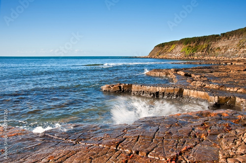 Photo: Kimmeridge Bay seascape with rock ledges extending out to sea on Kimmeridge Bay seascape with rock ledges extending out to sea on