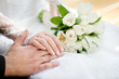Hands of the groom and the bride with wedding rings