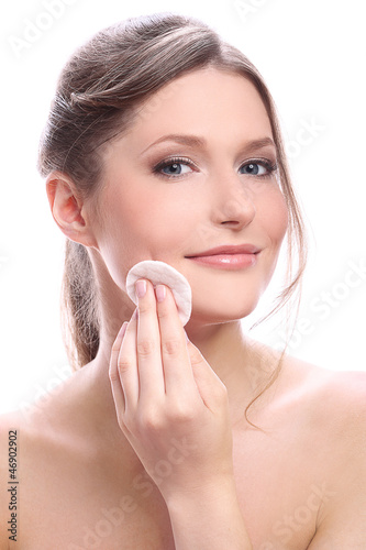 Photo: Attractive and happy woman cleaning her face Attractive and happy woman cleaning her face