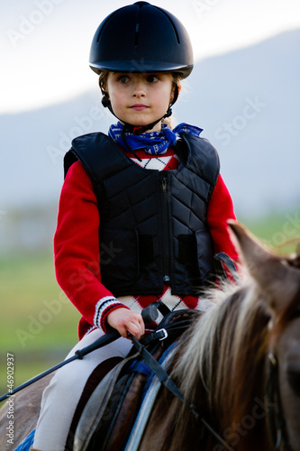 Photo: Horse riding - portrait of lovely equestrian on a horse Horse riding - portrait of lovely equestrian on a horse