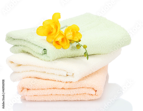 Photo: colorful towels and flowers isolated on white colorful towels and flowers isolated on white