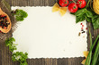 paper for recipes vegetables, and spices on wooden table