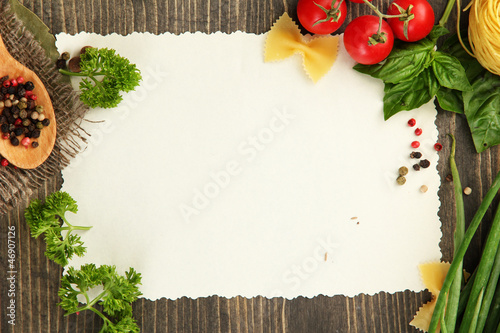 Photo: paper for recipes vegetables, and spices on wooden table paper for recipes vegetables, and spices on wooden table