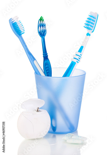 Photo: Toothbrushes, chewing gum and dental floss isolated on white Toothbrushes, chewing gum and dental floss isolated on white