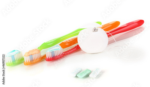 Photo: Toothbrush, chewing gum and dental floss isolated on white Toothbrush, chewing gum and dental floss isolated on white