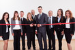 Management about to cut the red ribbon