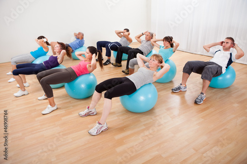 Photo: Class of diverse people doing pilates Class of diverse people doing pilates