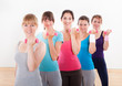 Aerobics class working out with dumbbells