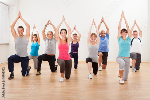 Photo: Group of people doing aerobics exercises Group of people doing aerobics exercises