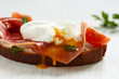 Sandwich with poached egg, parma ham and cream cheese