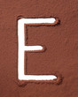 Letter E made of cocoa powder