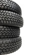 Stack of four car wheel winter tyres isolated