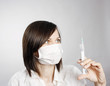 Nurse in mask with syringe