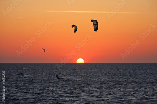 Photo: kitesurfers at sunset kitesurfers at sunset