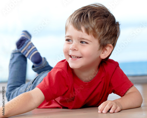 Photo: Three years old boy having fun on the floor Three years old boy having fun on the floor