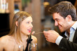 Romantic couple having dinner, man feeding woman