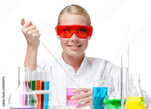 Photo: Chemist tests purple liquid in beaker, isolated on white Chemist tests purple liquid in beaker, isolated on white