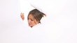 beautiful smiling girl breaks the wall paper to see out and give