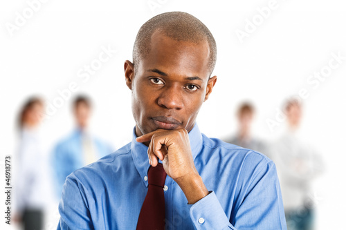 Photo: Businessman in front of his team Businessman in front of his team