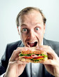 Funny business man eating sandwich