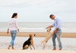 Portrait of a happy couple with dogs at the beach
