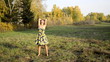 Young woman dancing in the autumn park