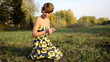 Young woman sitting on the grass in the autumn park