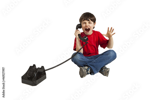 Photo: angry child on the phone, isolated on white background angry child on the phone, isolated on white background