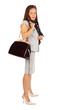 Young beautiful business woman holds bag in studio on white