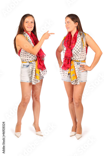 Photo: Two same women in studio on white background. Two same women in studio on white background.