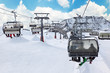 Ski chair-lift with skiers in snow-capped mountains in Austrian
