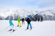 Skiers prepare for slope at winter in beautiful snowy mountains.