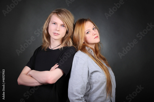 Photo: Long hair boy and brown hair girl lean pose in photo studio Long hair boy and brown hair girl lean pose in photo studio
